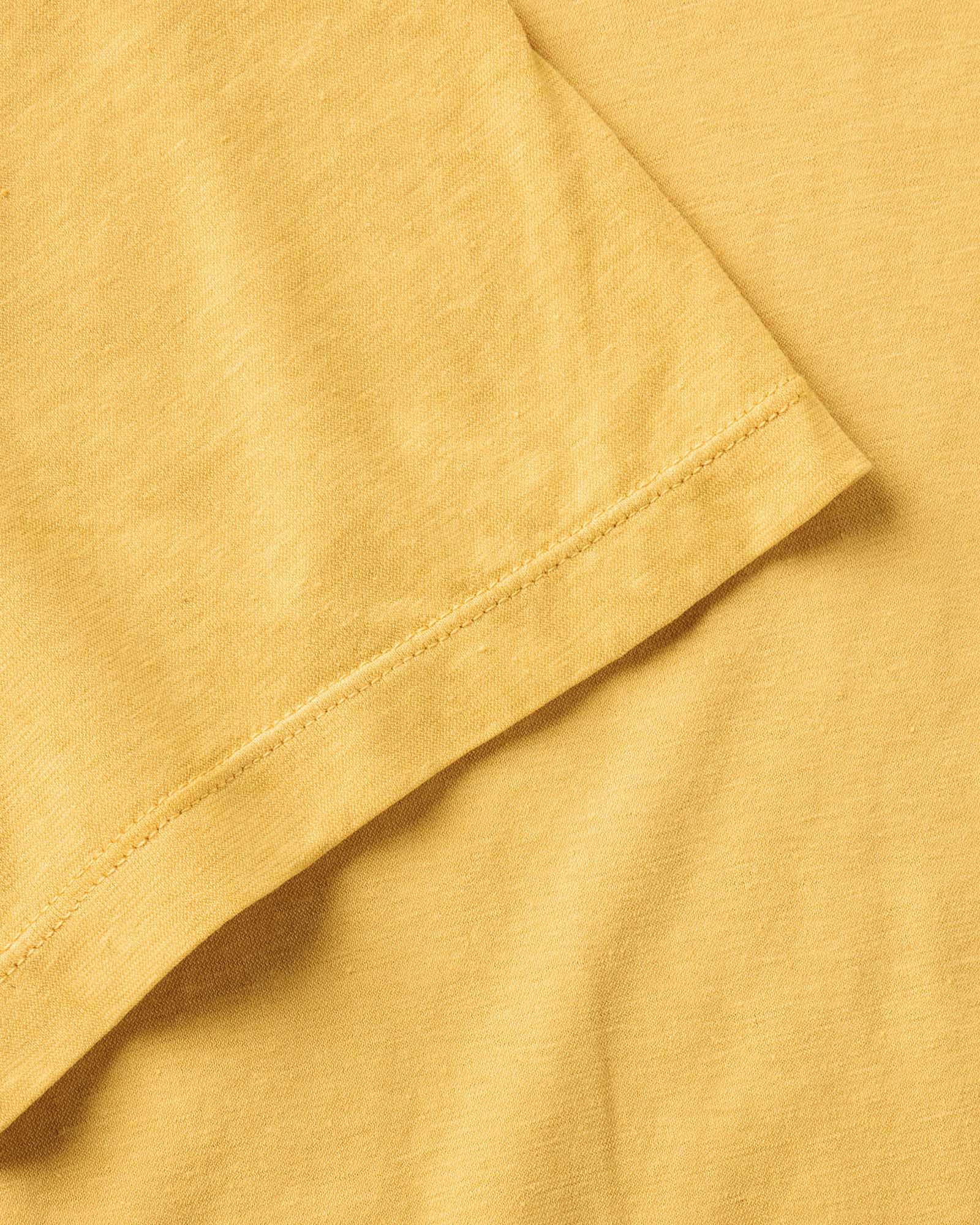 material shot of the sleeve on The Cotton Hemp Tee in Goldfinch, Knits by Taylor Stitch