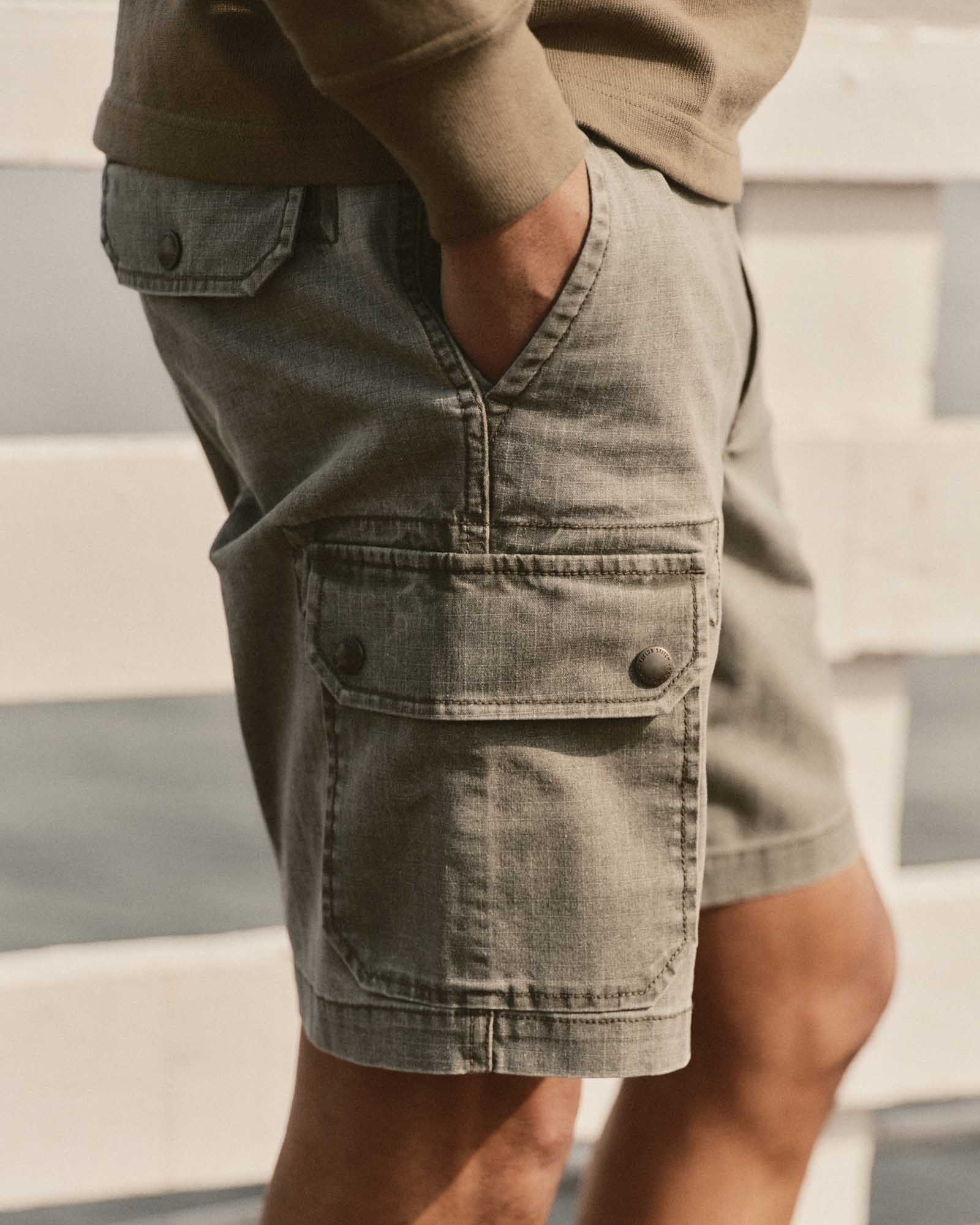 fit model with his hand in his pocket wearing The Scout Short in Burnt Olive Ripstop, Bottoms by Taylor Stitch