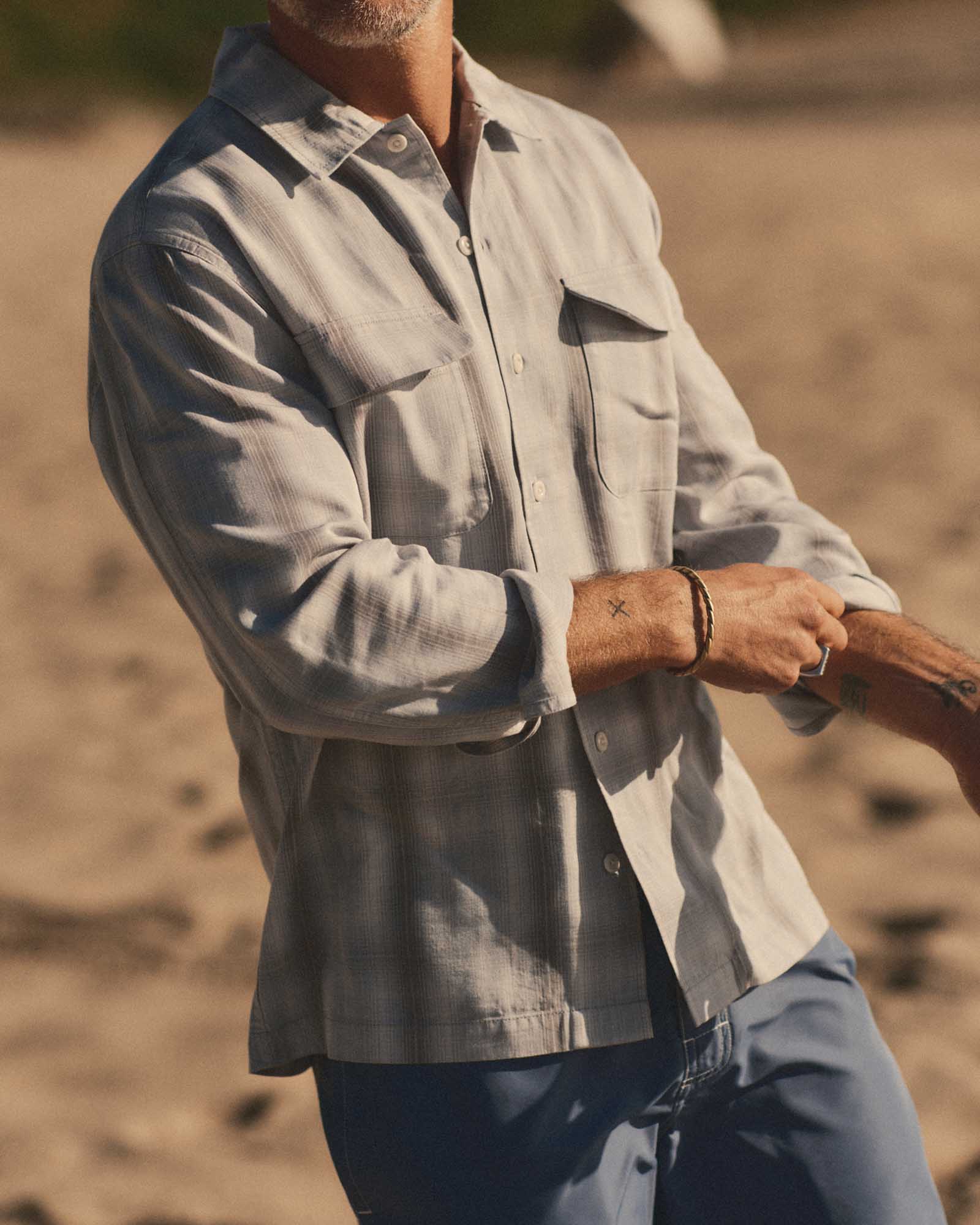 fit model posing in The Shore Shirt in Fog Check Tencel, Wovens by Taylor Stitch
