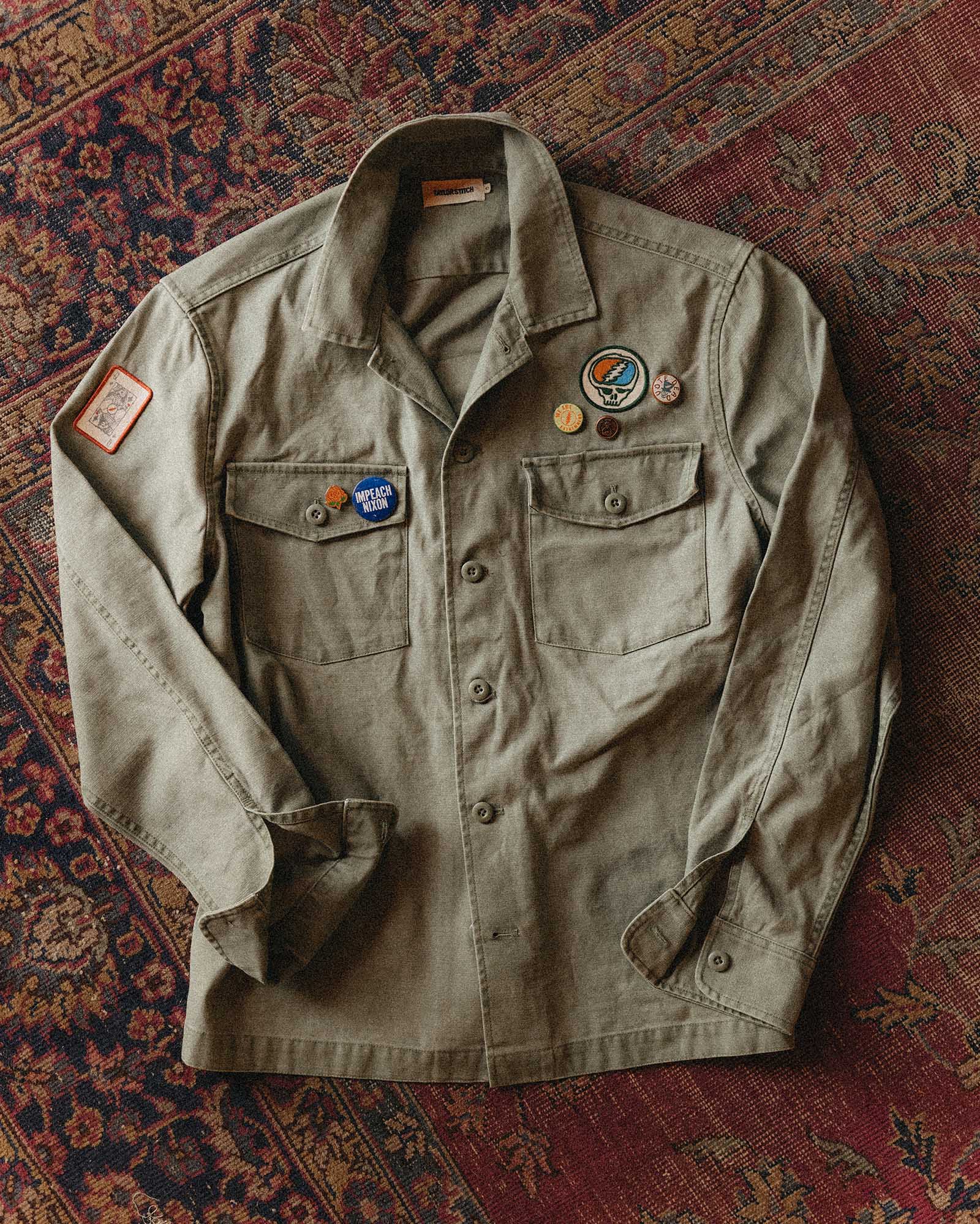 editorial flatlay of The Surplus Shirt in Field Olive Reverse Sateen, Wovens by Taylor Stitch