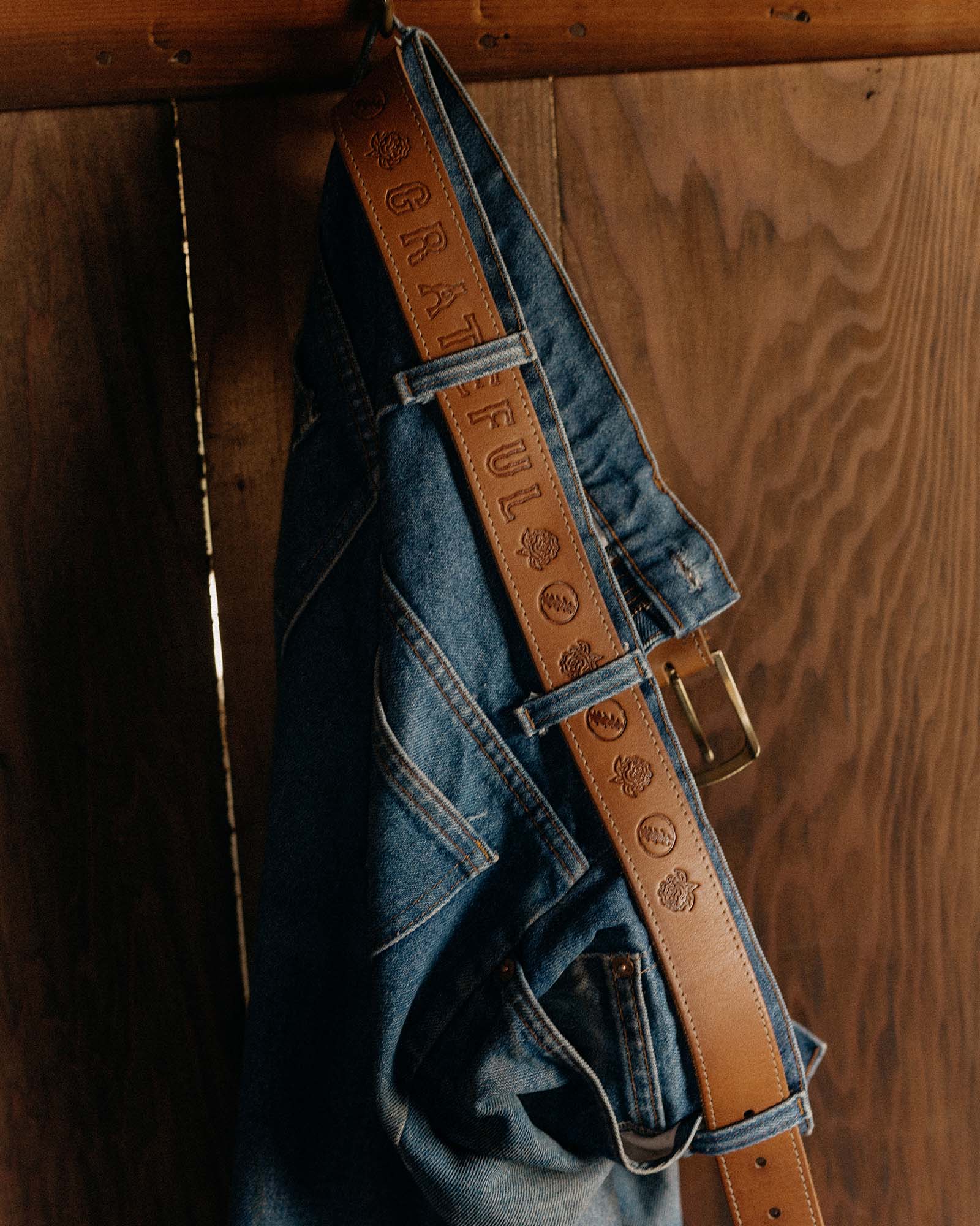 editorial image of The Tour Belt in Washed Saddle on jeans, Accessories by Taylor Stitch