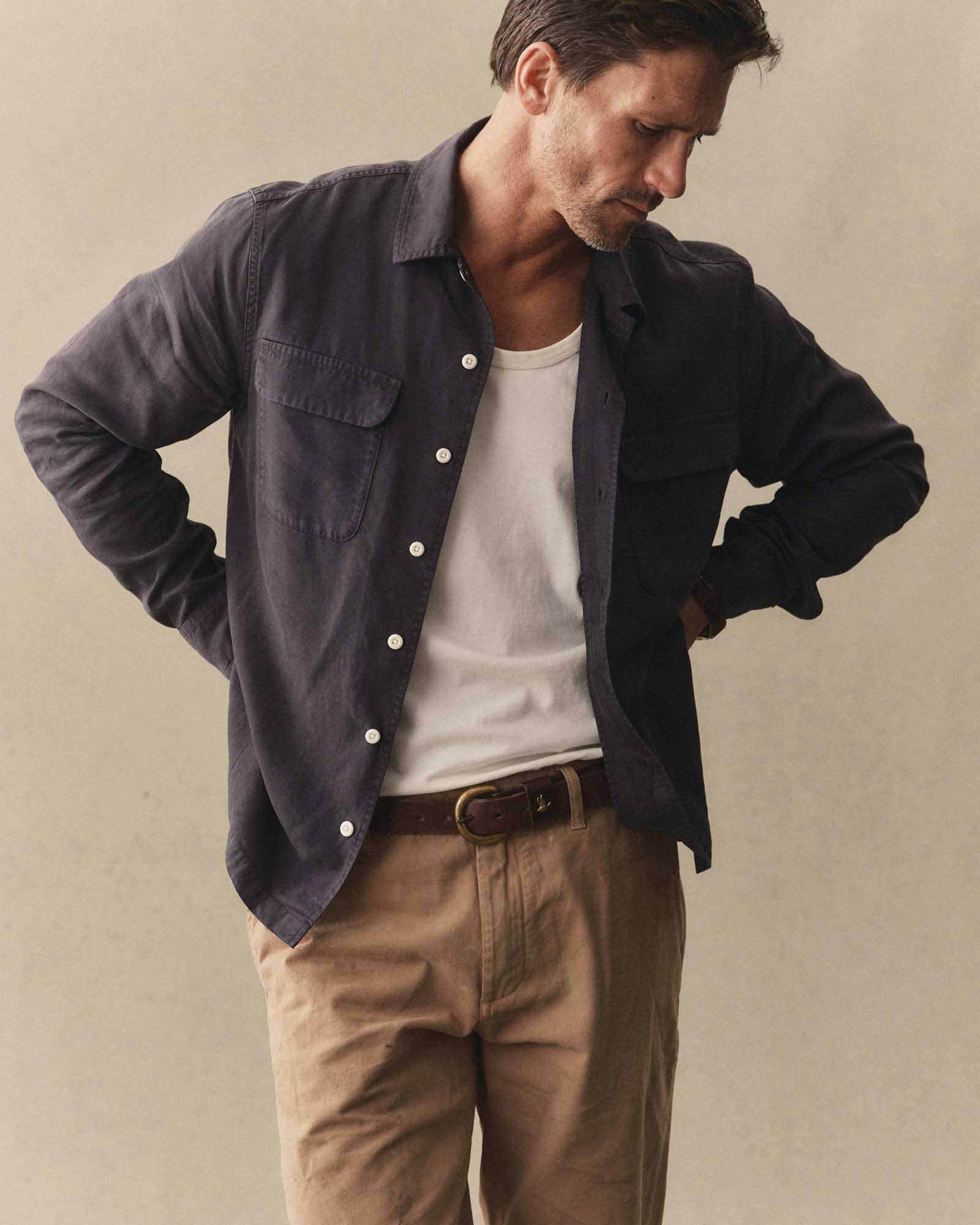 fit model posing in The Shore Shirt in Navy Tencel, Wovens by Taylor Stitch