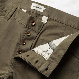 material shot of the button fly on The Chore Pant in Stone Boss Duck, Bottoms by Taylor Stitch
