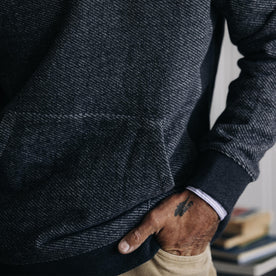 fit model with his hand in the pocket of The Briggs Pullover in Coal French Terry Twill Knit