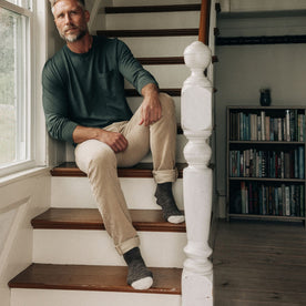 fit model sitting on the stairs on The Camp Sock in Soil Marl