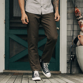 fit model standing in front of a doorway in The Carmel Pant in Timber Guncheck