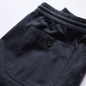 material shot of the back pocket of The Apres Pant in Navy Twist Jaspe Twill