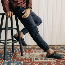 fit model sitting in The Apres Pant in Navy Twist Jaspe Twill