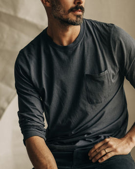 fit model sitting wearing The Cotton Hemp Long Sleeve Tee in Charcoal, Knits by Taylor Stitch
