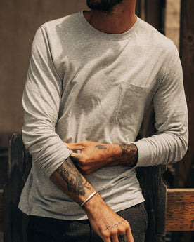 fit model adjusting sleeves on The Cotton Hemp Long Sleeve Tee in Heather Grey, Knits by Taylor Stitch