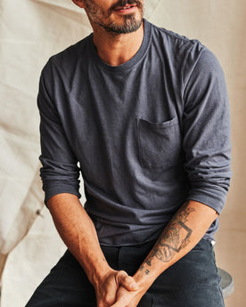 fit model sitting wearing The Cotton Hemp Long Sleeve Tee in Navy, Knits by Taylor Stitch