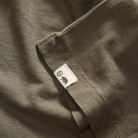 material shot of the hem with the TS label on The Cotton Hemp Tee in Olive