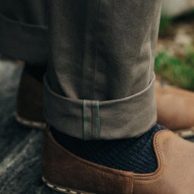 fit model showing off selvage cuffs on The Democratic All Day Pant in Fatigue Olive Selvage Denim