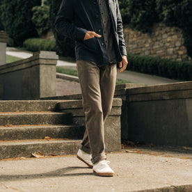 fit model walking wearing The Democratic All Day Pant in Fatigue Olive Selvage Denim