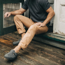 fit model sitting wearing The Democratic All Day Pant in Tobacco Selvage Denim