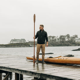 fit model on a dock in the Quarter Zip Tanker Sweater in Loden