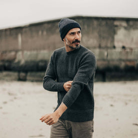 fit model adjusting his sleeves in The Headland Beanie in Dark Navy