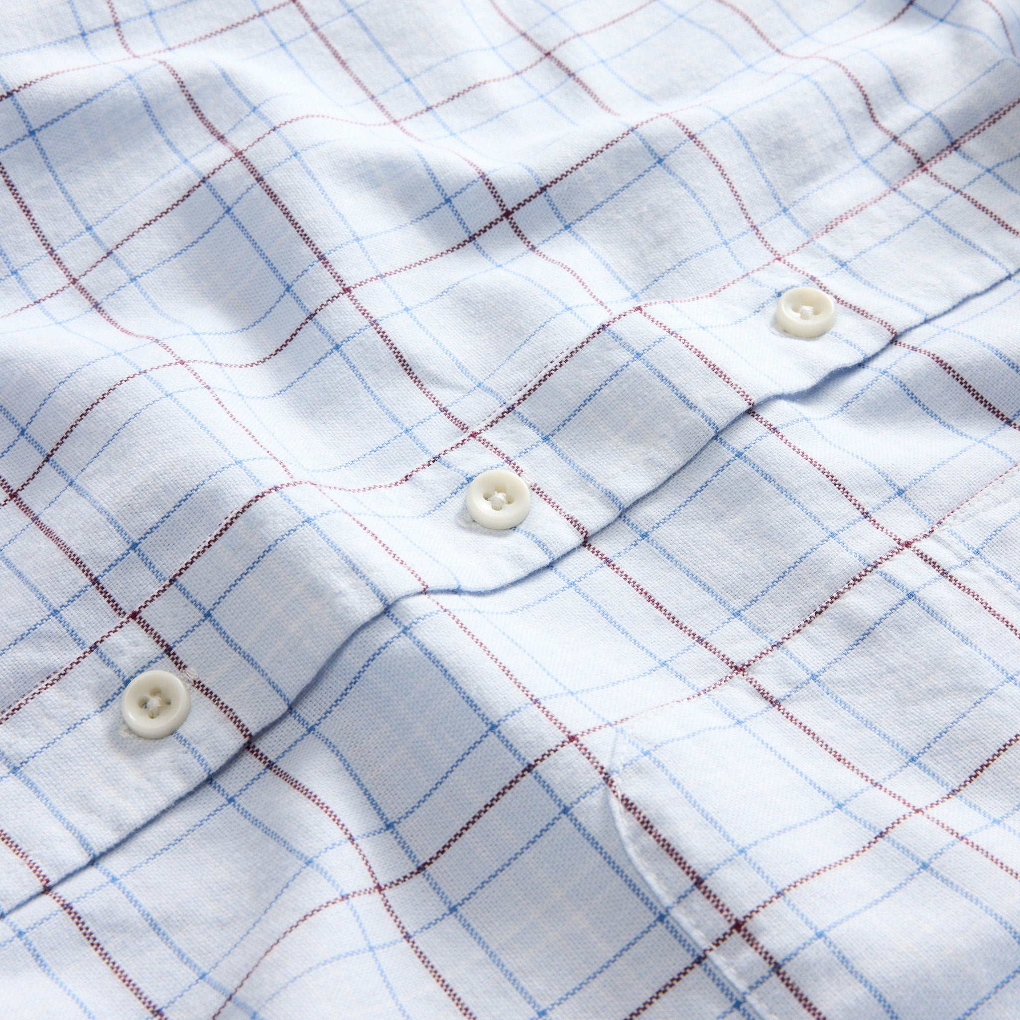 material shot of the buttons on The Jack in Blue Fade Plaid, Wovens by Taylor Stitch