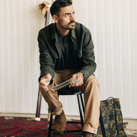 fit model sitting posing in The Ledge Shirt in Dark Forest Linen Tweed