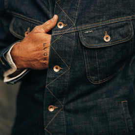 fit model showing off buttons on The Long Haul Jacket in Rinsed Organic Selvage