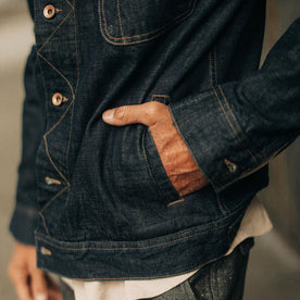 fit model with his hand in the pocket of The Long Haul Jacket in Rinsed Organic Selvage
