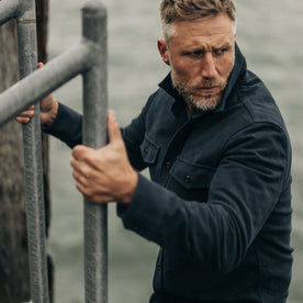 fit model going down a ladder in The Maritime Shirt Jacket in Dark Navy Moleskin