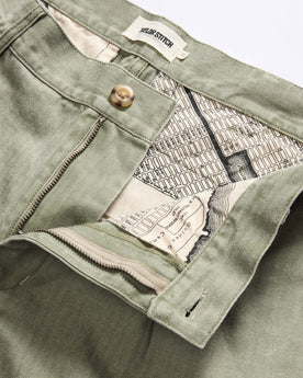 material shot of the waistband on The Matlow Pant in Dried Sage Pigment Herringbone, Bottoms by Taylor Stitch