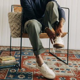 fit model sitting wearing The Matlow Pant in Dried Sage Pigment Herringbone