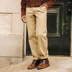 fit model with his hand in his pocket wearing The Matlow Pant in Light Khaki Pigment Herringbone