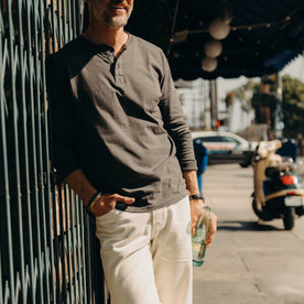 fit model posing in The Organic Cotton Henley in Faded Black