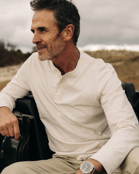 fit model posing in The Organic Cotton Henley in Vintage White, Knits by Taylor Stitch