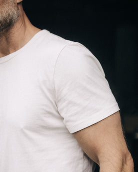 fit model showing off sleeves on The Organic Cotton Tee in Vintage White, Knits by Taylor Stitch