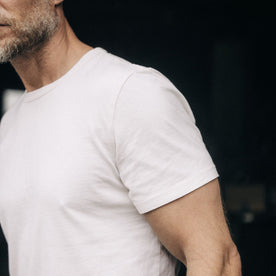 fit model showing off sleeves on The Organic Cotton Tee in Vintage White