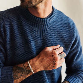 fit model posing in The Russell Sweater in Heather Blue