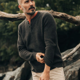 fit model adjusting sleeves on The Sidecountry Sweater in Coffee Heather Merino Waffle