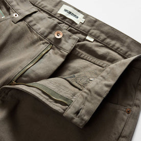 material shot of the waistband on The Slim All Day Pant in Fatigue Olive Selvage Denim