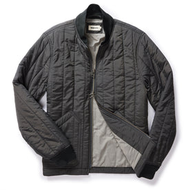 flatlay of The Able Jacket in Faded Black Quilted Nylon, shown half zipped