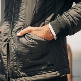 fit model with his hands in the pockets of The Able Jacket in Faded Black Quilted Nylon