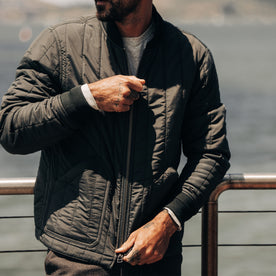 fit model zipping up The Able Jacket in Faded Black Quilted Nylon
