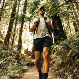 fit model walking down the hill wearing The Challenge Cargo Short in Black