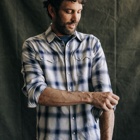 fit model adjusting the sleeves on The Frontier Shirt in Indigo Shadow Plaid