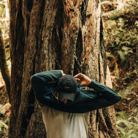 fit model putting on The Merino Half Zip in Forest