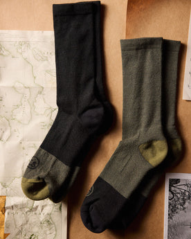 flatlay of The Merino Sock in Black next to other socks, Accessories by Taylor Stitch