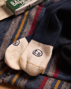 material shot of the logo on the toes of The Merino Sock in Navy, Accessories by Taylor Stitch