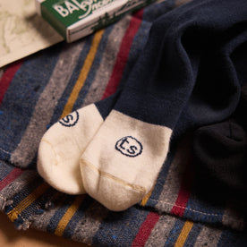 material shot of the logo on the toes of The Merino Sock in Navy