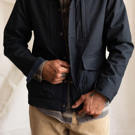 fit model zipping up The Pathfinder Jacket in Dark Navy Dry Wax