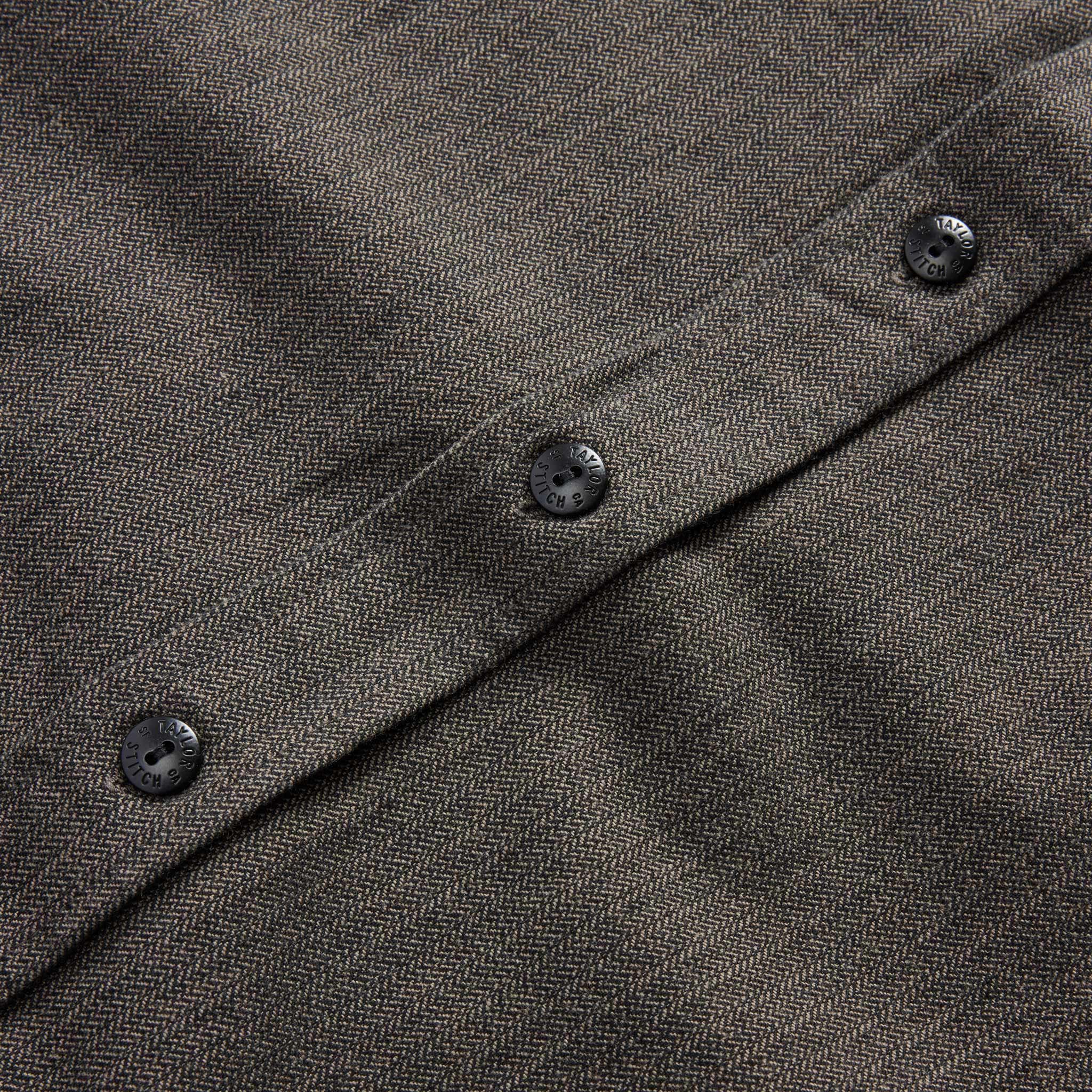 material shot of the button of The Utility Shirt in Olive Broken Herringbone, Wovens by Taylor Stitch