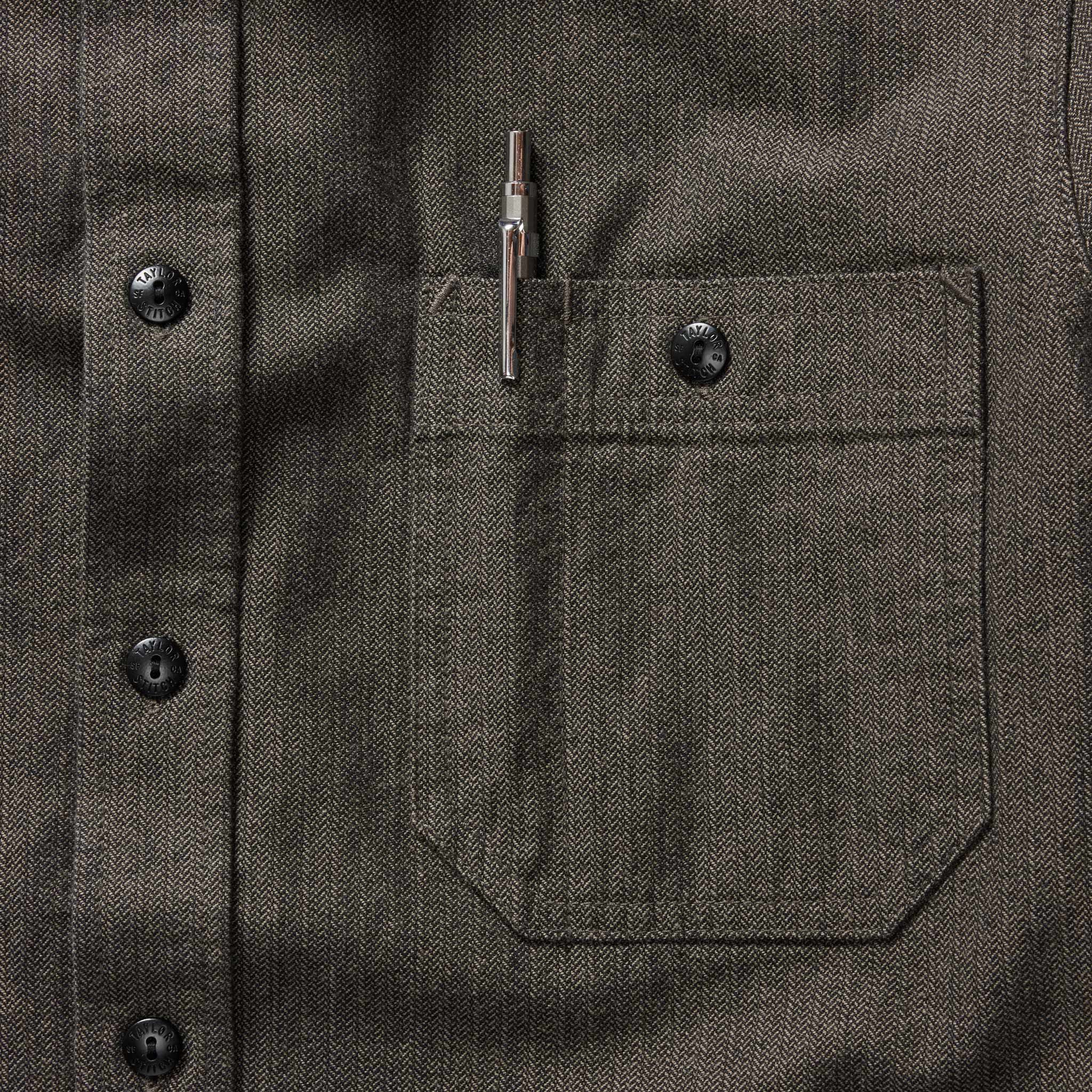 material shot of the chest pocket with pen holder on The Utility Shirt in Olive Broken Herringbone, Wovens by Taylor Stitch