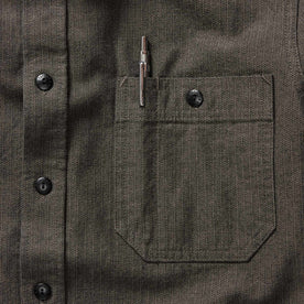 material shot of the chest pocket with pen holder on The Utility Shirt in Olive Broken Herringbone