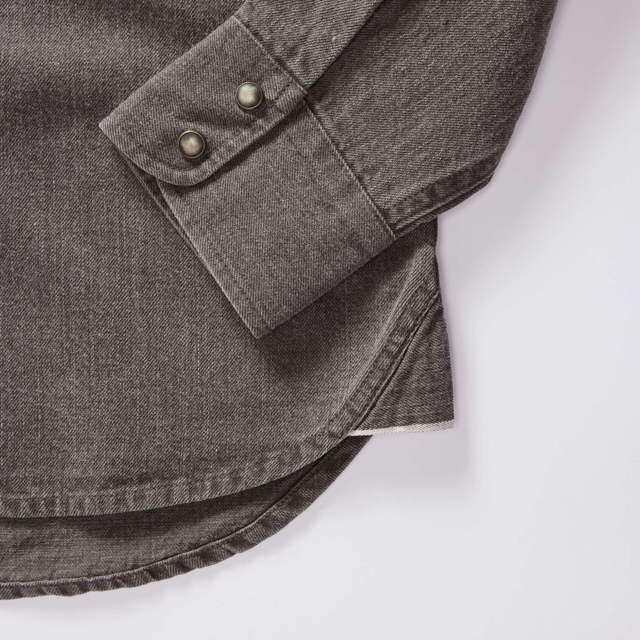 material shot of the cuffs on The Western Shirt in Soil Pigment Selvage Denim, Wovens by Taylor Stitch